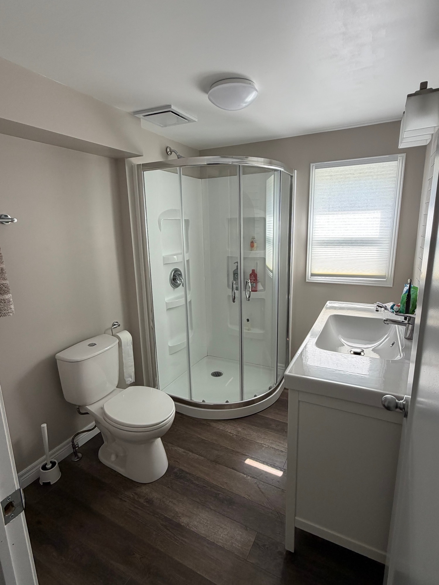 Bathroom renovation with curved glass shower enclosure