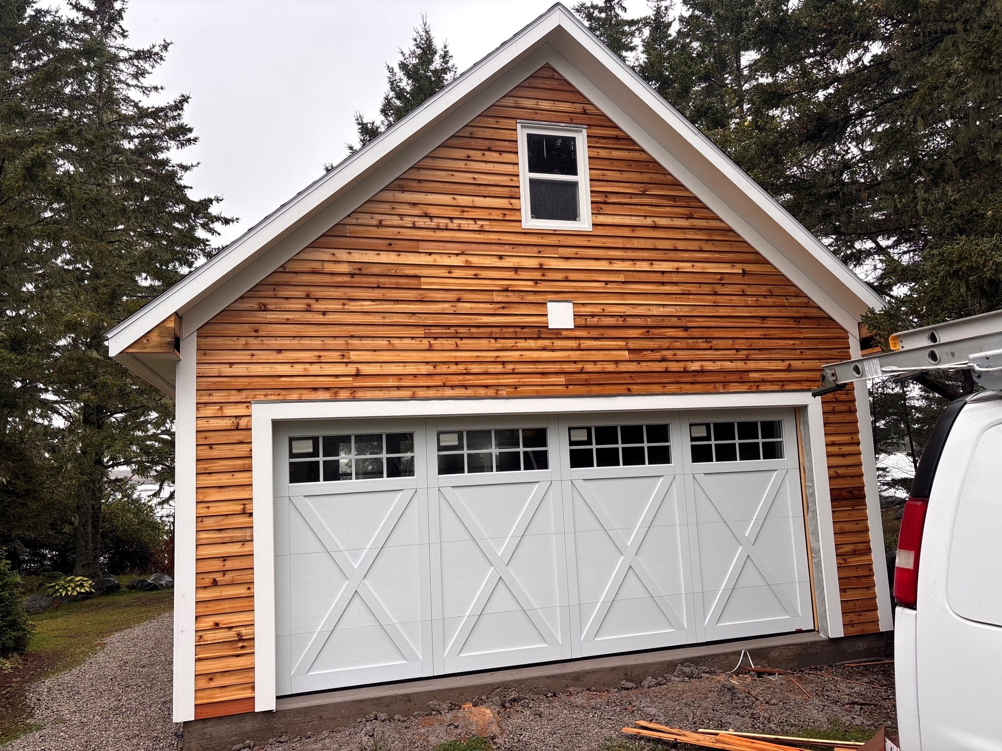 Cedar-clad garage with carriage-style doors