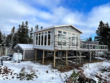 Residential construction exterior in winter — elevated build on South Shore