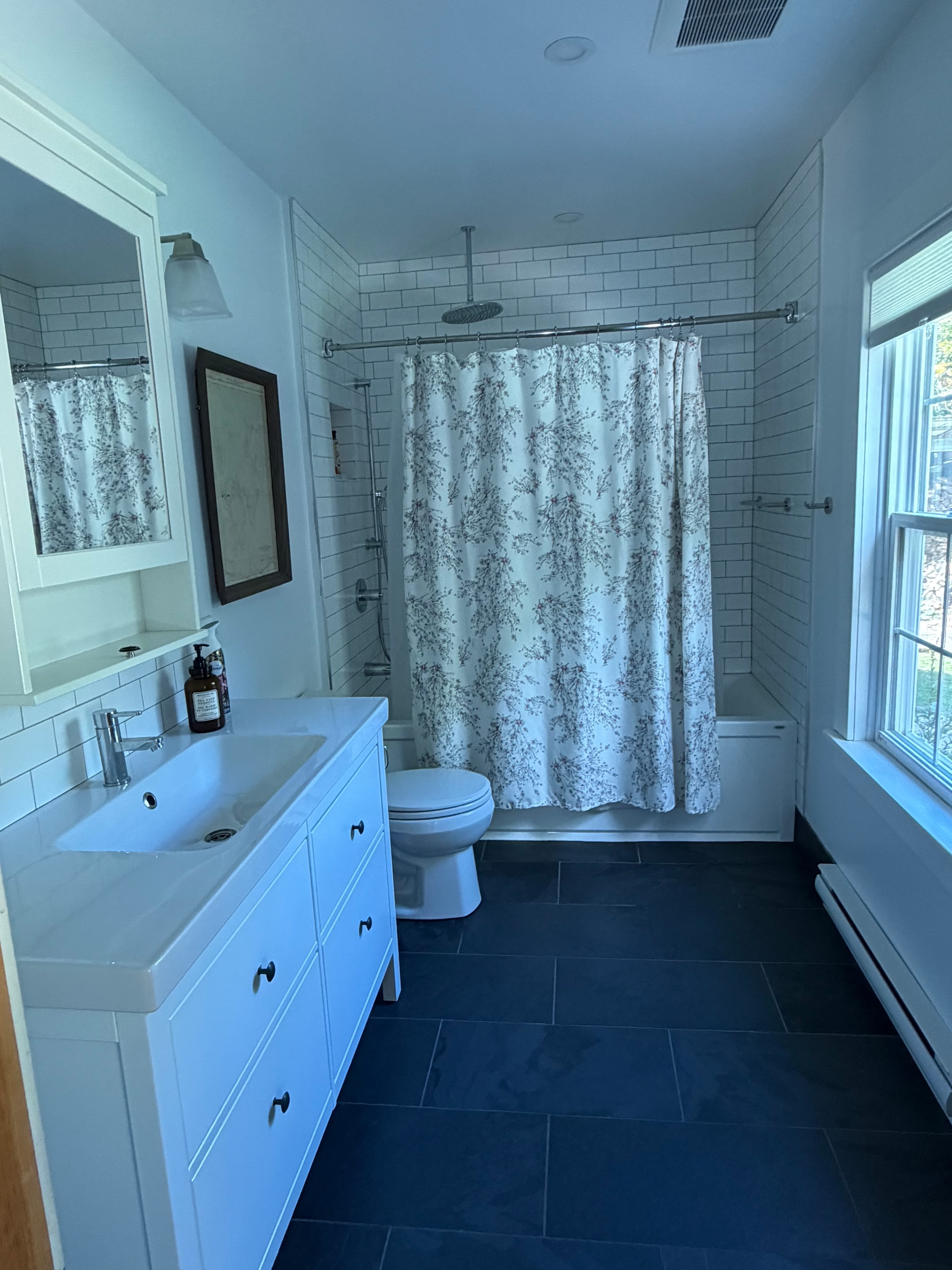 Renovated bathroom — white subway tile, slate floor, rain shower