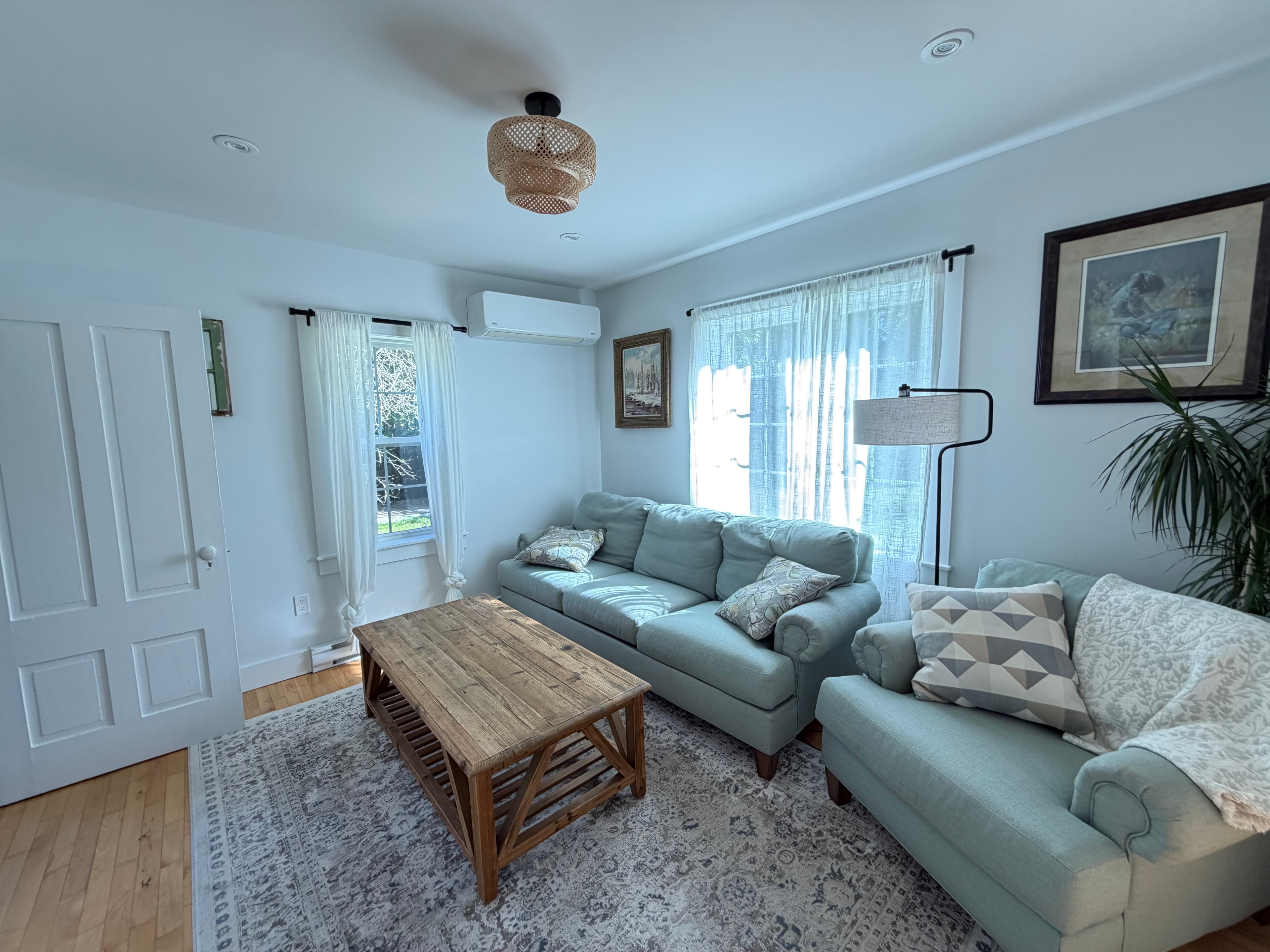 Renovated living room — second angle with natural light and coastal décor